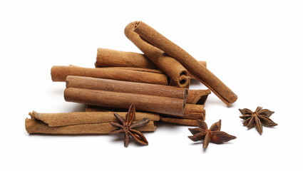 Cinnamon sticks and star anise pile isolated on white 