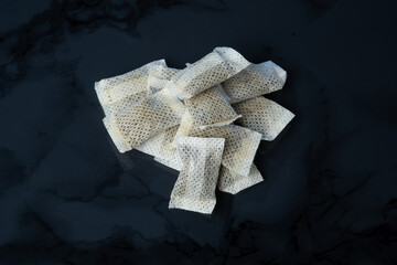 Closeup of a white swedish snus can and portion snuff pouches.