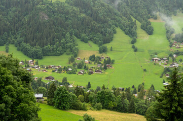 Panoramic view on mountain villages, green forests and apline meadows near Saint-Gervais-les-Bains,...