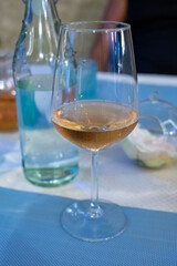 Summer on French Riviera Cote d'Azur, drinking cold rose from Cotes de Provence on outdoor terrase in old cafe, Var, France