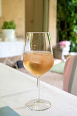 Summer on French Riviera Cote d'Azur, drinking cold rose from Cotes de Provence on outdoor terrase in old cafe, Var, France