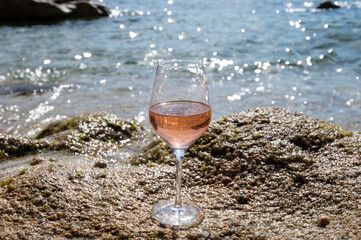 Summer time in Provence, glass of cold rose wine on sandy beach near Saint-Tropez, Var department, France
