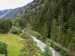 Fototapeta na wymiar View on Bon Nant mountain river, green forests and apline meadows near Saint-Gervais-les-Bains, Savoy. France