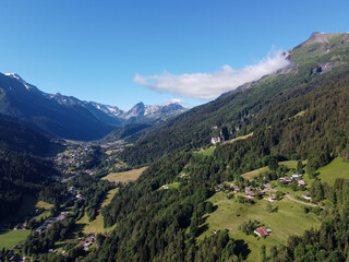 Panoramic view on mountain villages, green forests and apline meadows near Saint-Gervais-les-Bains, Savoy. France