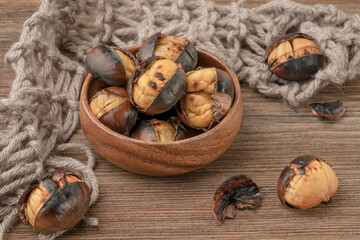 roasted chestnuts in the bowl on wooden table