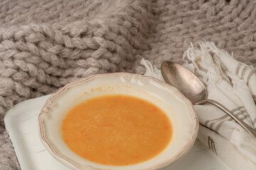 bowl of pumpkin soup on the bed in winter