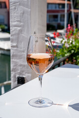 Summer on French Riviera Cote d'Azur, drinking cold rose wine from Cotes de Provence on outdoor terrase in Port Grimaud, Var, France