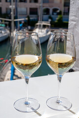 Summer on French Riviera Cote d'Azur, drinking cold dry white wine from Cotes de Provence on outdoor terrase in Port Grimaud, Var, France