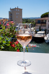Summer on French Riviera Cote d'Azur, drinking cold rose wine from Cotes de Provence on outdoor terrase in Port Grimaud, Var, France