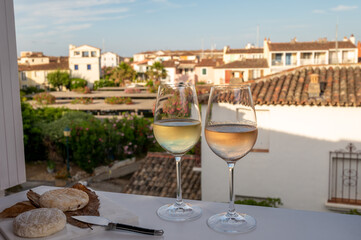 Summer on French Riviera Cote d'Azur, drinking cold rose and white wine from Cotes de Provence on outdoor terrase in Port Grimaud, Var, France