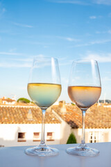 Summer on French Riviera Cote d'Azur, drinking cold rose and white wine from Cotes de Provence on outdoor terrase in Port Grimaud, Var, France