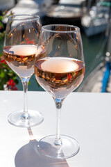 Summer on French Riviera Cote d'Azur, drinking cold rose wine from Cotes de Provence on outdoor terrase in Port Grimaud, Var, France