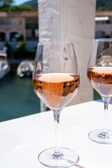 Summer on French Riviera Cote d'Azur, drinking cold rose wine from Cotes de Provence on outdoor terrase in Port Grimaud, Var, France