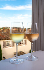 Summer on French Riviera Cote d'Azur, drinking cold rose and white wine from Cotes de Provence on outdoor terrase in Port Grimaud, Var, France