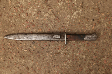 old bayonet knife with scabbard on the ground