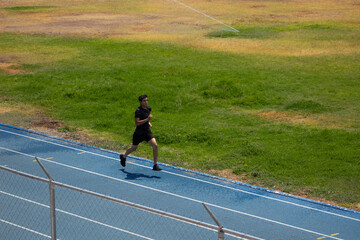 runner training alone next to a field