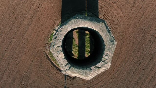 Top down view of a 19th Century limestone tower The Daymark in a meadow on the coast in Kingswear, Devon, UK