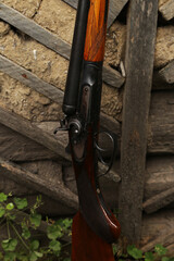 Vintage shotgun near an old wall