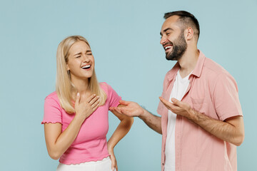 Young fun couple two friends family man woman in casual clothes tell joke talk speaking laughing...