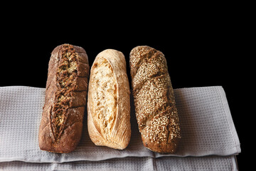 An assortment of bread on a napkin. Isolated on black