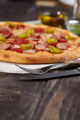 tasty pizza on the wooden background