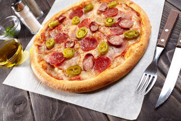 tasty pizza on the wooden background
