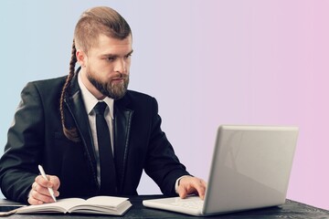Man using a laptop against office background