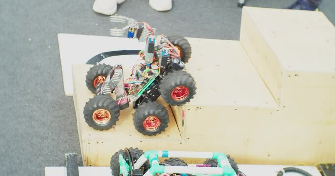 small homemade robots on wheels demonstrate their capabilities and skills. close-up.