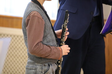 Music teacher teaching pupil with musical instrument in hand in school class at lesson.Close-up photo.Child development and education concept