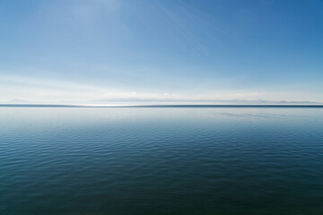 Blue lake and mountains in the sunny day. Beautiful seascape landscape.