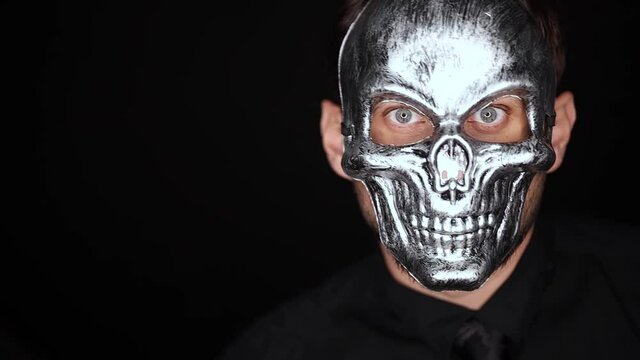 a man in a skeleton mask on a black background