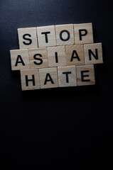 Text message for protest action. Selective focus on Lettering Stop Asian Hate. Banner on black...