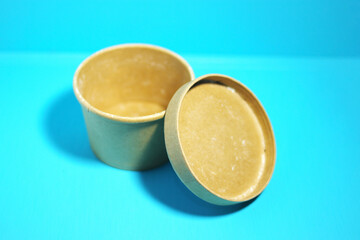 Close-up view of round cardboard box isolated on blue background