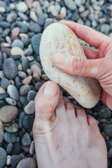 Peeling and care of toe nails with pebble sea stone