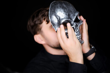a skeleton mask that a man wants to put on his face