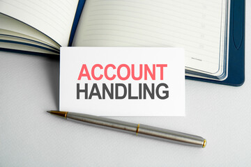 Business concept. Text account handling writing on paper card, notebook on wooden background.