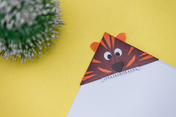 Cute origami bookmark symbol of 2022 new year tiger. DIY concept.