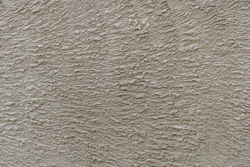 abstract background of an old embossed plastered concrete wall close up