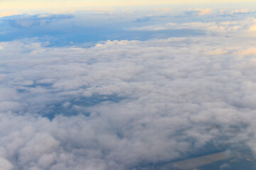 Beautiful white clouds in blue sky. View from airplane