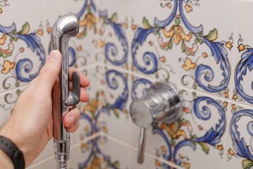 Man using bidet in toilet or bathroom. Male hygiene