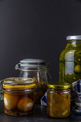 Batch of home made marrow chutney jars and pickled eggs gherkins, portrait, copyspace.