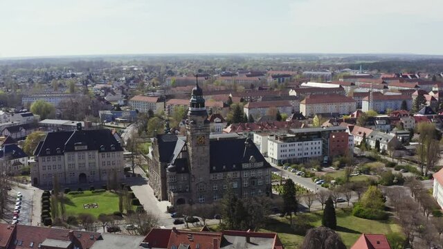 The drone flies towards the town hall of Wittenberge and the camera pans down. Small town in Brandenburg Germany.