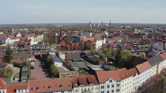 Drone flight over Wittenberge a small town in Brandenburg Germany. In the foreground you can see the tower of the town hall.