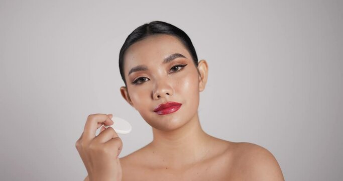 Close up of Beauty Asian woman holding makeup powder puff