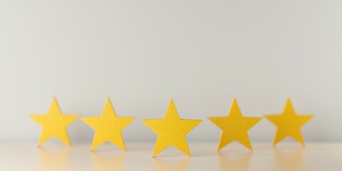 Five yellow wooden stars on table in row with selective focus on center star, five star review for best service or product quality concept
