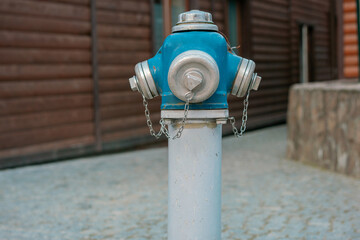 Blue and grey hydrant with chains installed on the street. Security. Water. Fire. Control. Safety....