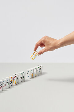 Woman taking domino piece