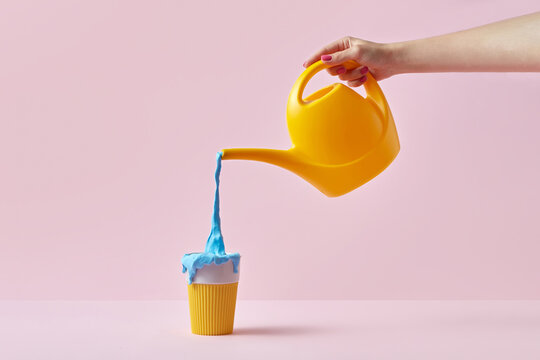 Woman with watering can and coffee cup