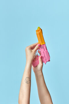 Woman putting condom on gun
