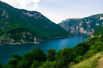 Naklejka na ściany i meble Summer landscape of lake and river Piva between high green mountains near Pluzine. Montenegro.